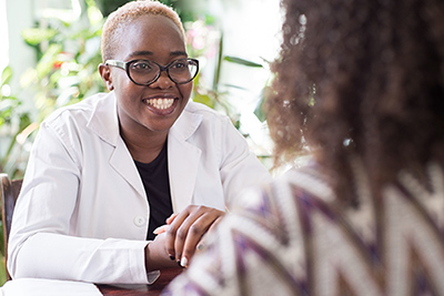a-young-african-american-female-doctor-with-glasses-shakes-hands-with-a-patient-as-a-sign-of-trust-of-a-doctor-people-of-mixed-race-in-the-doctors-office